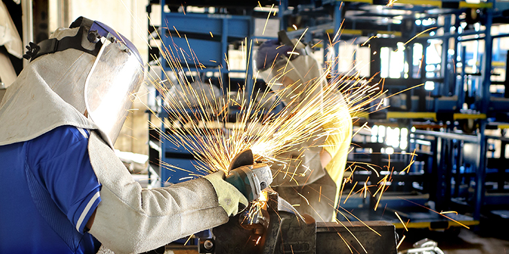 two men welding button